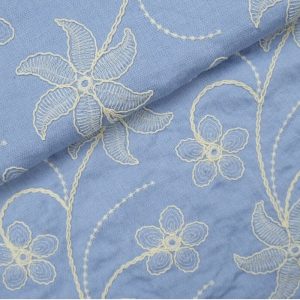 Broderie viscose stof, sierlijke bloemen motief, blauw/zand. P567